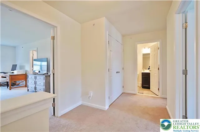 a view of a hallway to a livingroom and a livingroom with furniture
