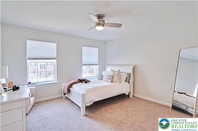 a spacious bedroom with a bed and a window