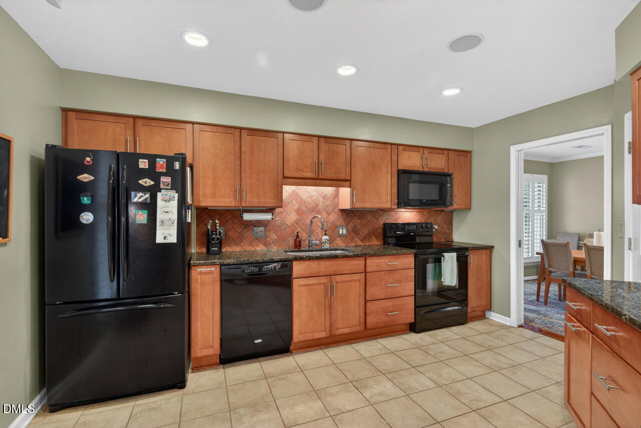 3307 Coachman's Way Durham, NC 27705 - Photo 10 of 50 a kitchen with granite countertop stainless steel appliances and refrigerator