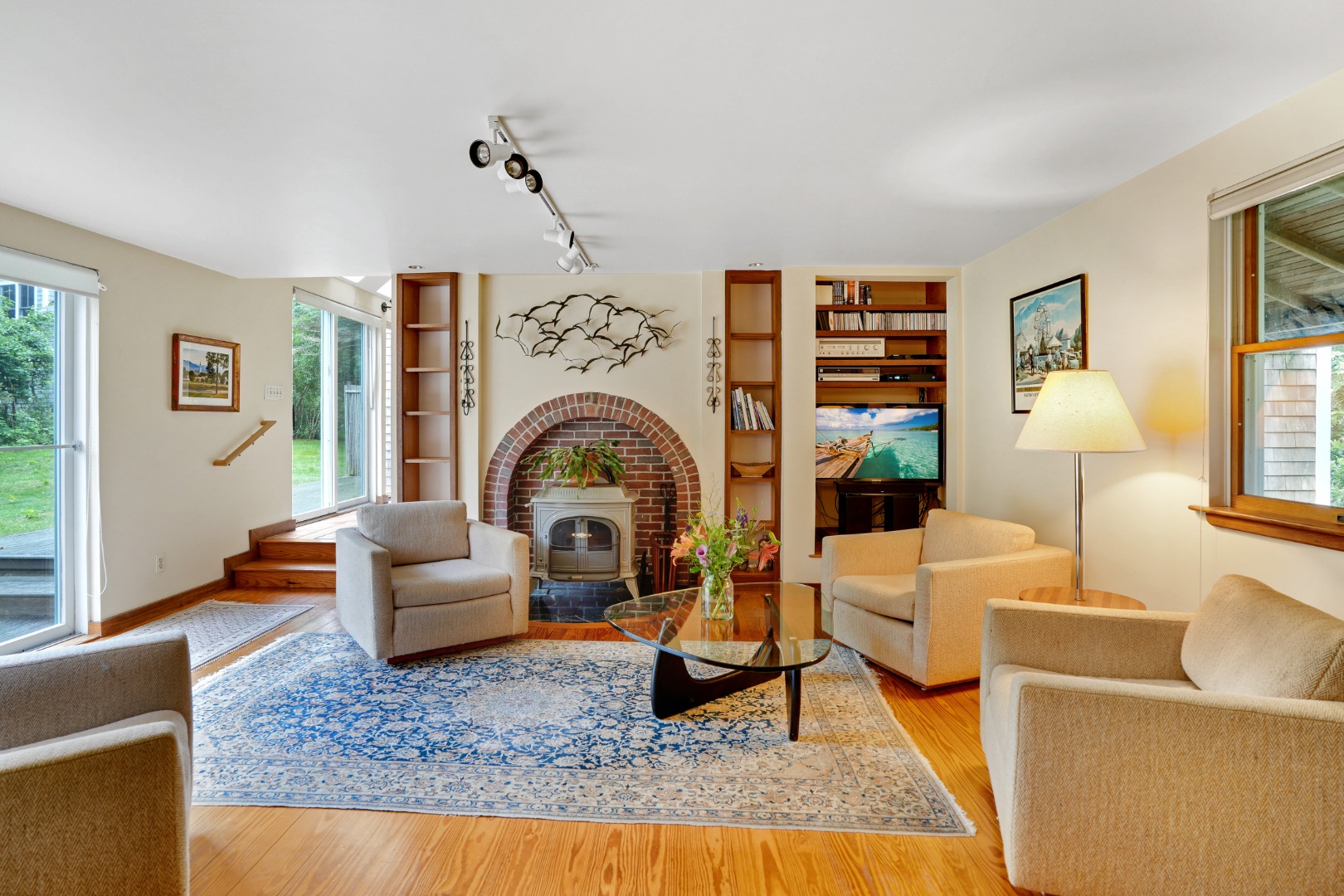 174 Middle Road Chilmark, MA 02535 - Photo 13 of 40 a living room with furniture a rug and a chandelier