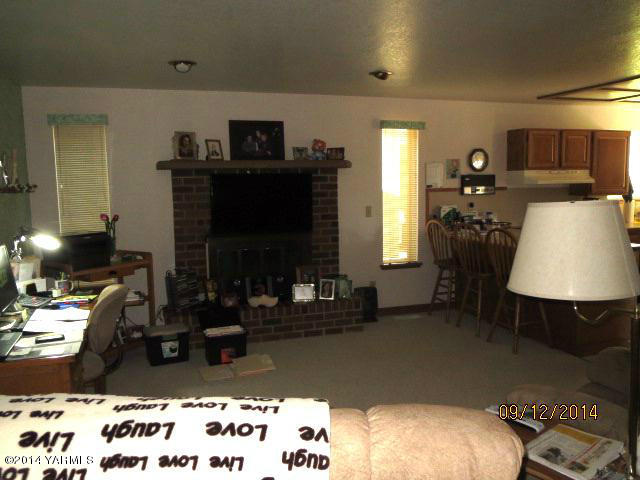 411 East Duffield Road Moxee, WA 98936 - Photo 9 of 19 a living room with furniture and a fireplace