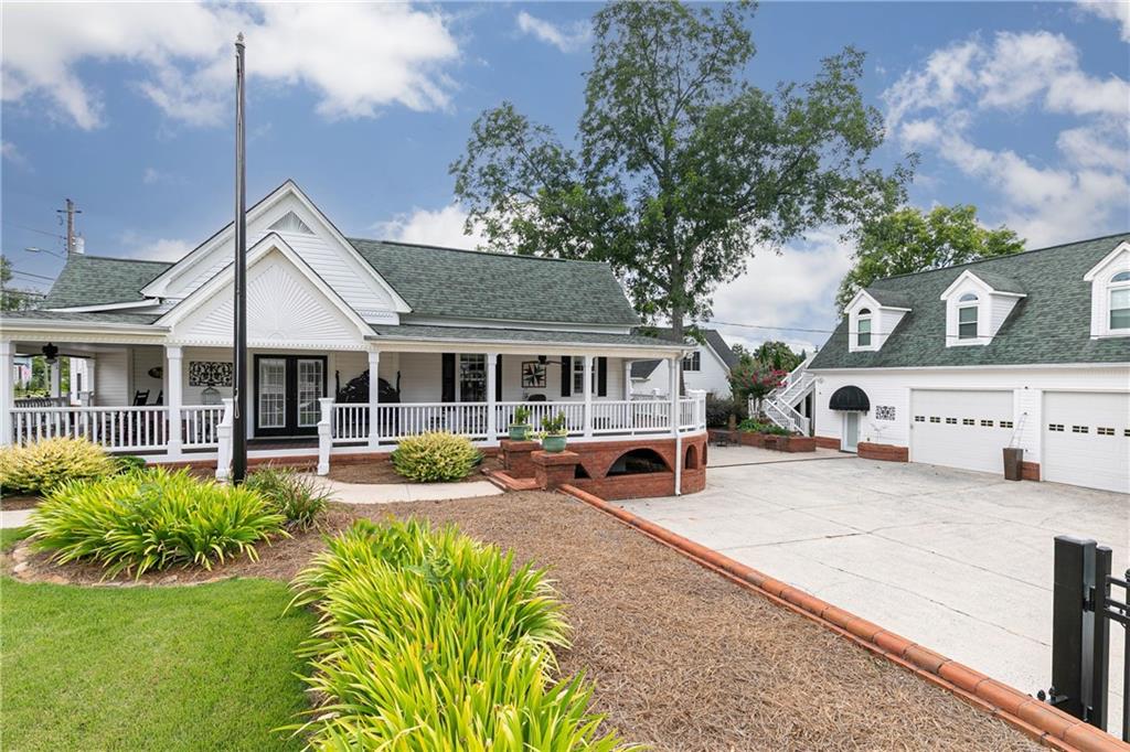 176 Confederate Avenue Dallas, GA 30132 - Photo 1 of 51 a front view of a house with a yard table and chairs