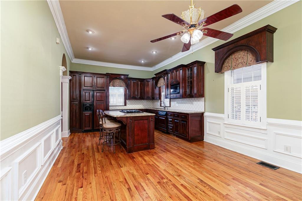 176 Confederate Avenue Dallas, GA 30132 - Photo 11 of 51 a large kitchen with stainless steel appliances granite countertop a stove and a wooden floors