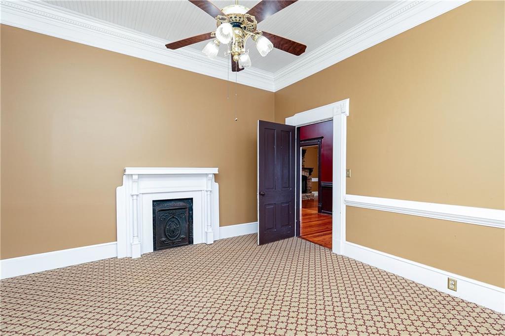 176 Confederate Avenue Dallas, GA 30132 - Photo 16 of 51 a view of an empty room with chandelier fan and fire place