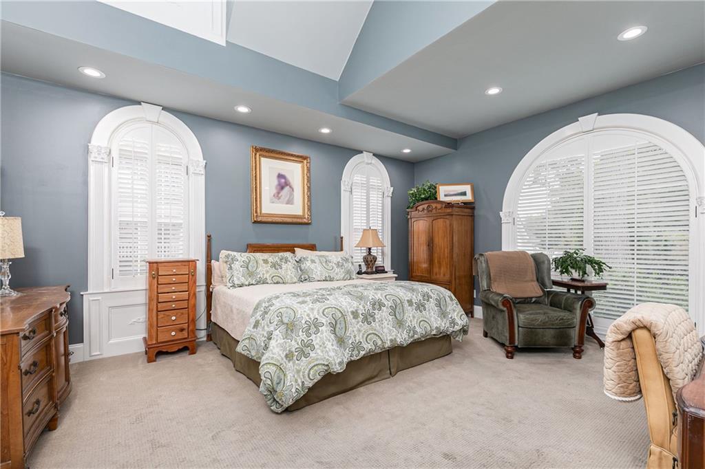 176 Confederate Avenue Dallas, GA 30132 - Photo 20 of 51 a spacious bedroom with a bed and a chandelier