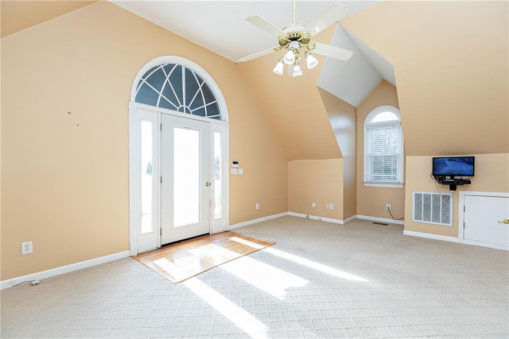 176 Confederate Avenue Dallas, GA 30132 - Photo 42 of 51 an empty room with chandelier fan and windows