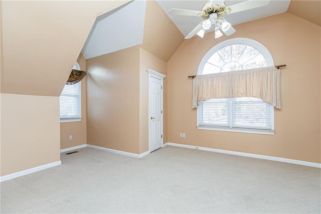 176 Confederate Avenue Dallas, GA 30132 - Photo 43 of 51 an empty room with a chandelier fan and windows