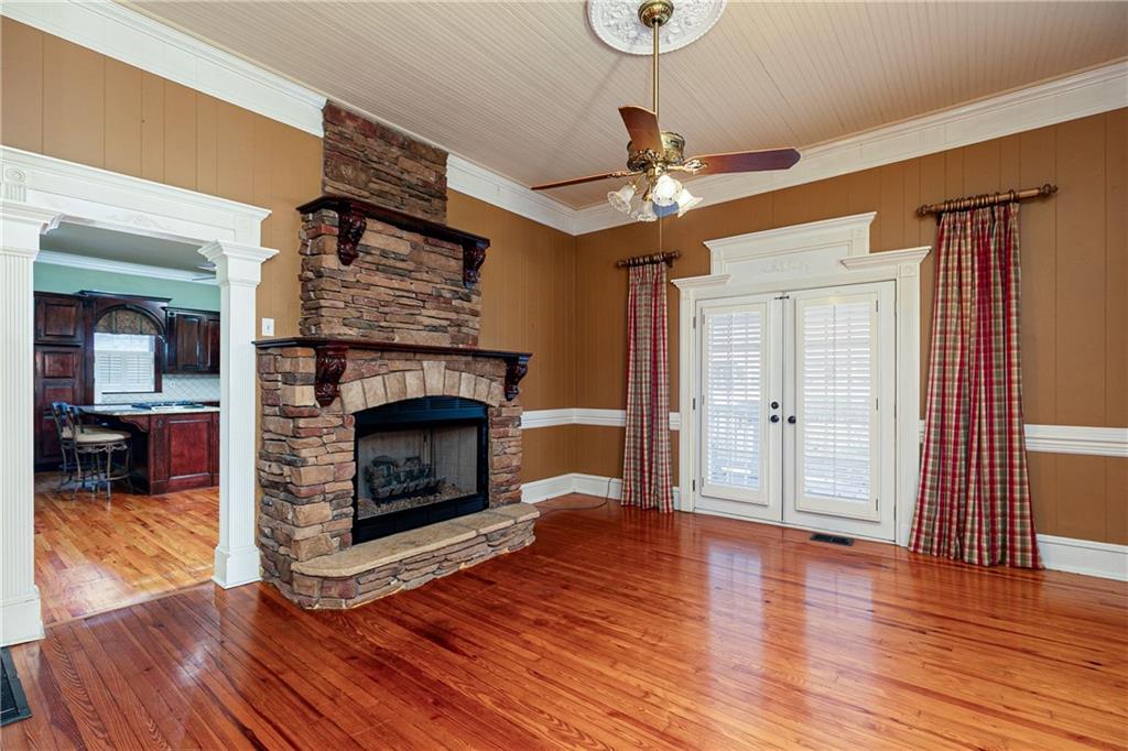 176 Confederate Avenue Dallas, GA 30132 - Photo 6 of 51 a living room with wooden floors and a fireplace