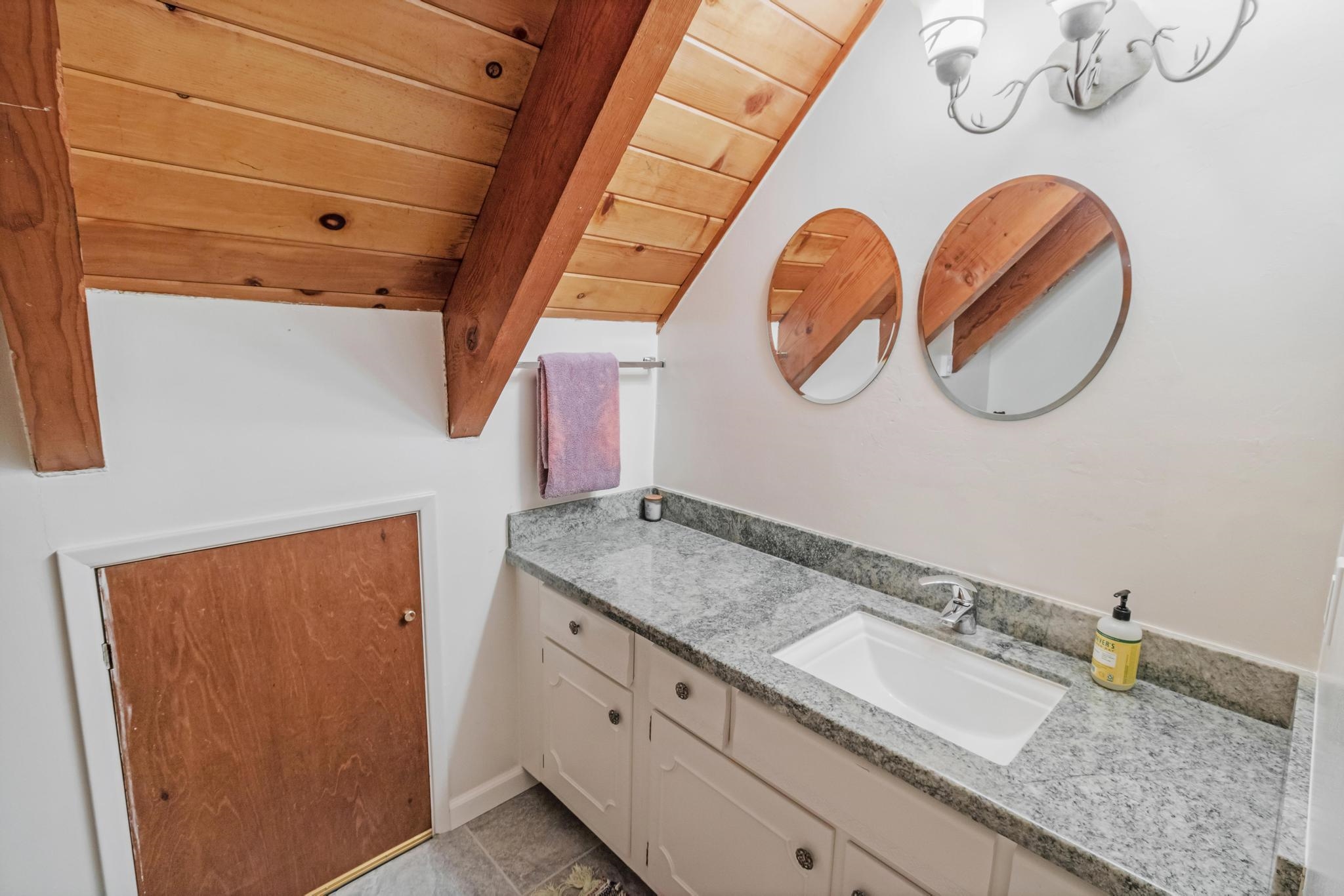 41158 Skyline Drive Emigrant Gap, CA 95715 - Photo 15 of 21 a bathroom with a granite countertop sink and a mirror