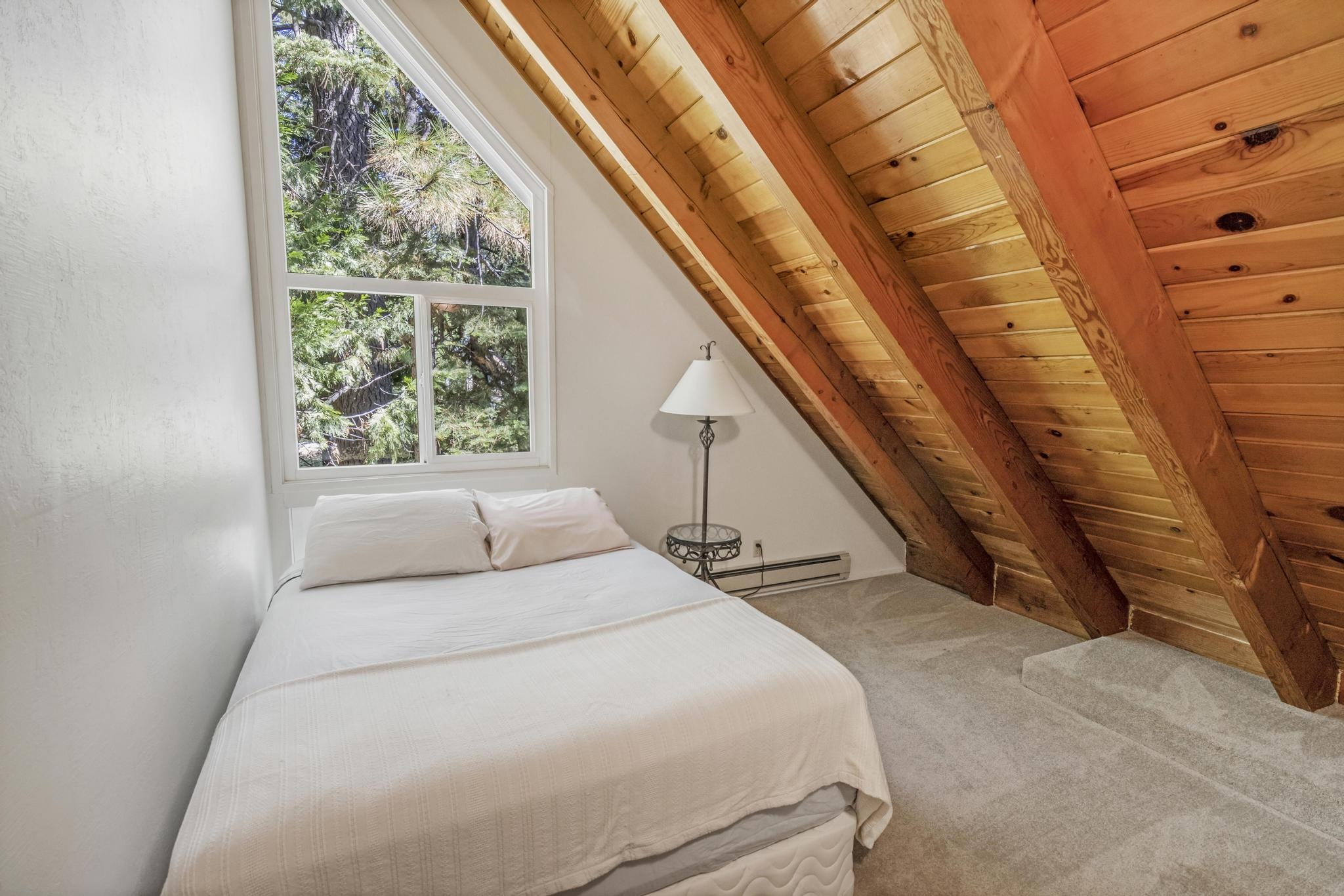 41158 Skyline Drive Emigrant Gap, CA 95715 - Photo 8 of 21 a bedroom with a large bed and a window