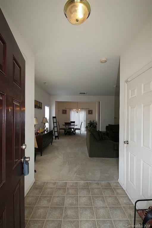 8941 Chalkstone Road Charlotte, NC 28216 - Photo 2 of 20 a living room with furniture and a chandelier