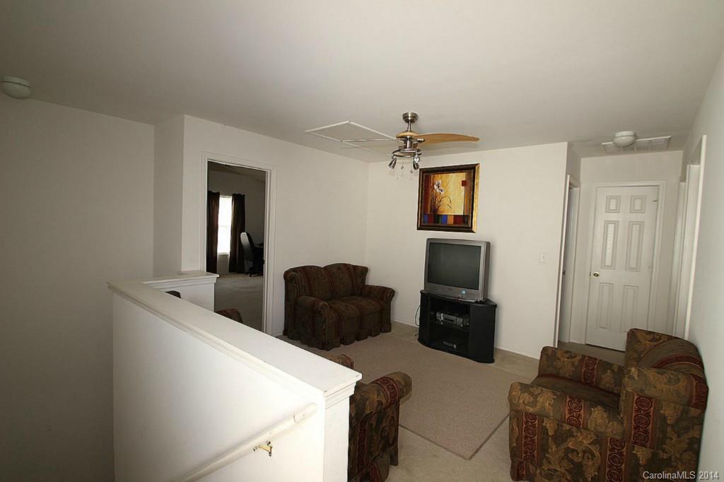 8941 Chalkstone Road Charlotte, NC 28216 - Photo 12 of 20 a living room with furniture and a flat screen tv