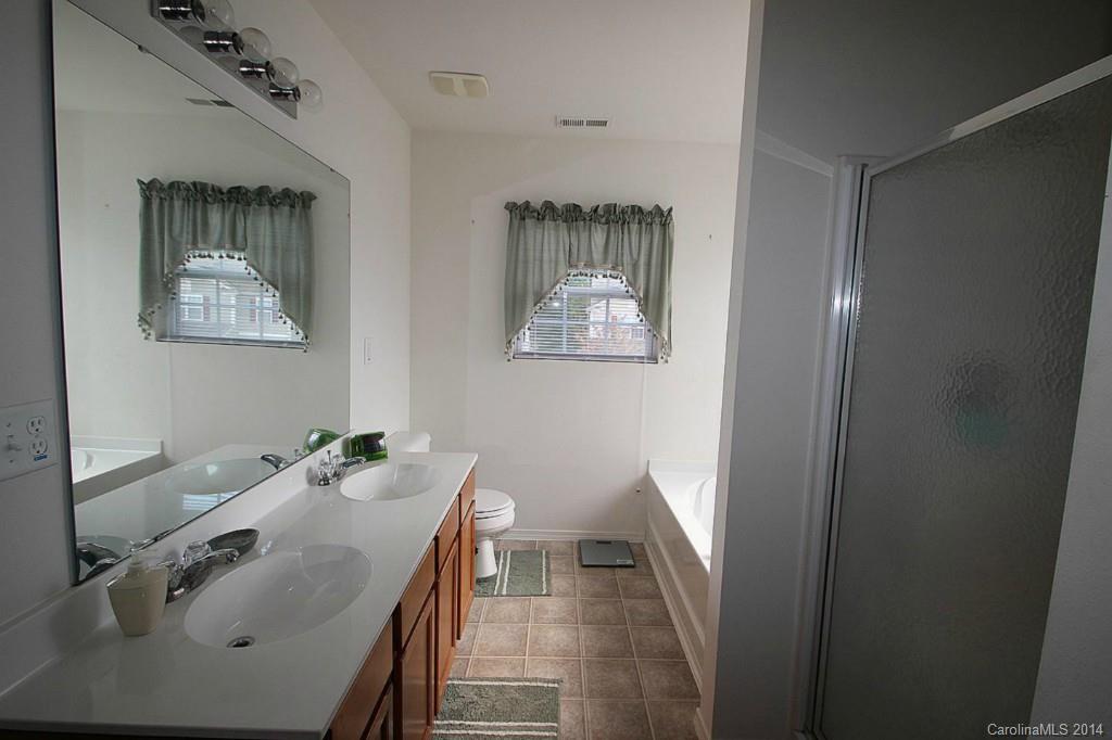 8941 Chalkstone Road Charlotte, NC 28216 - Photo 15 of 20 a bathroom with a sink and mirror with toilet