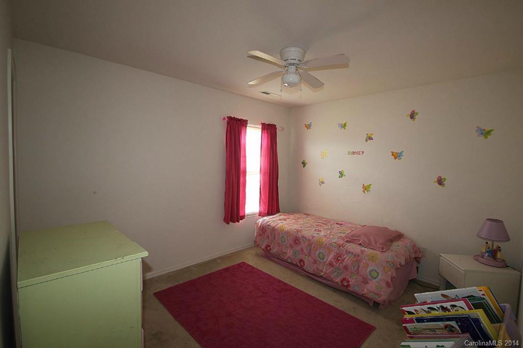 8941 Chalkstone Road Charlotte, NC 28216 - Photo 18 of 20 a bedroom with a bed and a chandelier