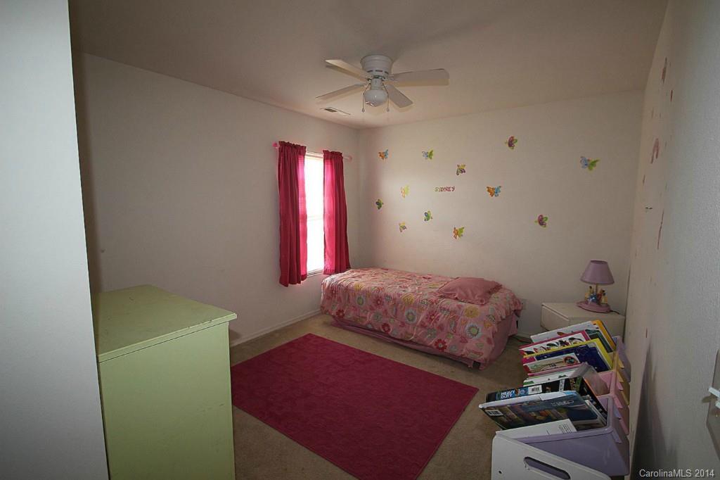 8941 Chalkstone Road Charlotte, NC 28216 - Photo 19 of 20 a bedroom with a bed and a chandelier