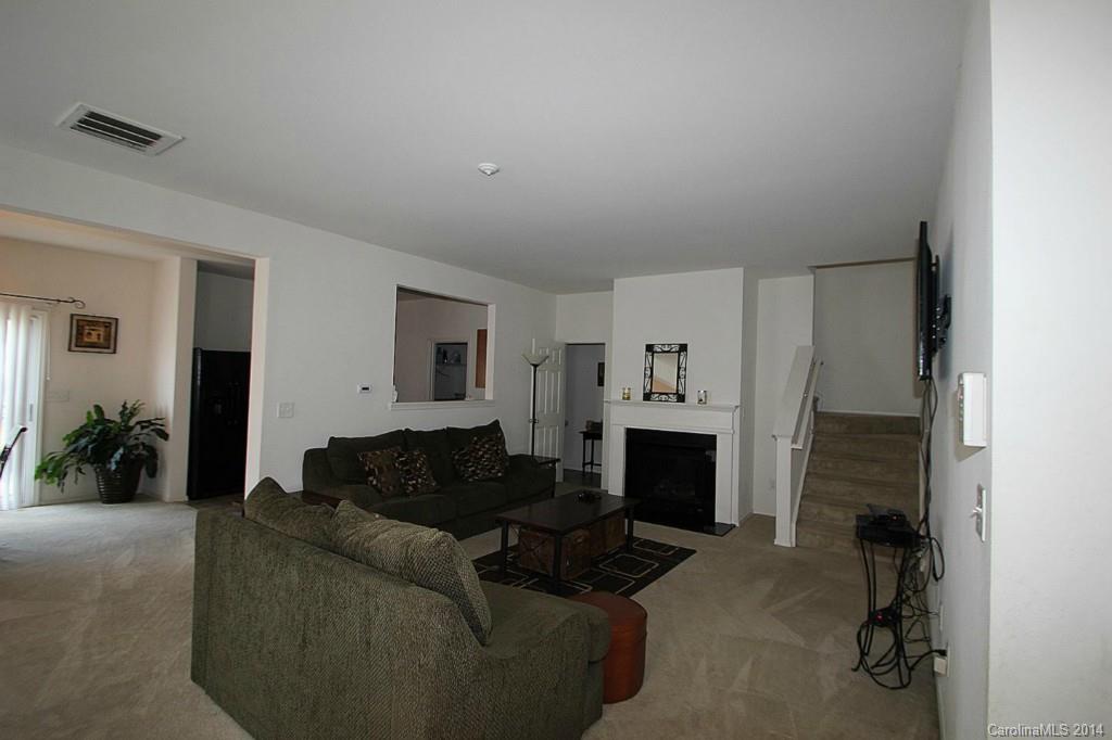 8941 Chalkstone Road Charlotte, NC 28216 - Photo 7 of 20 a living room with furniture and a fireplace