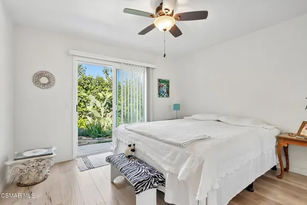 a bedroom with a bed a window and a chair