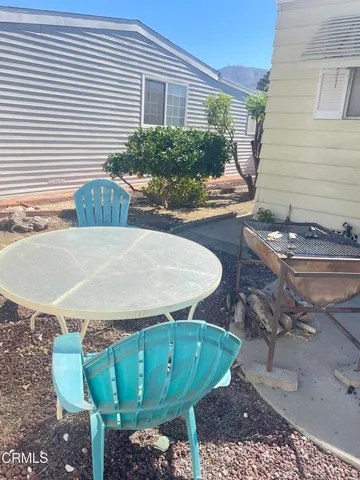 a view of a chairs and table in the patio