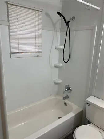 a white toilet sitting next to a white sink