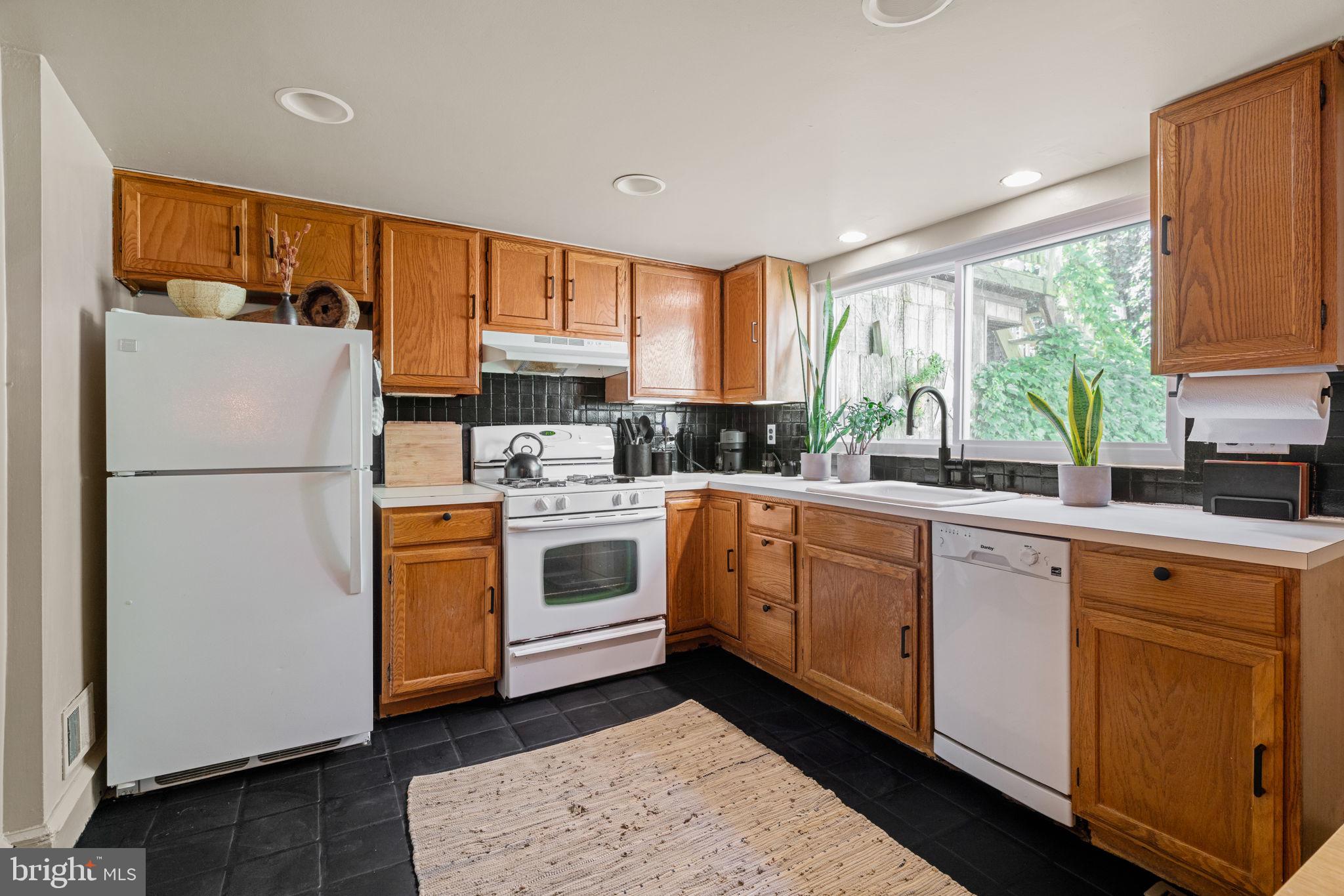 142 Carpenter Street Philadelphia, PA 19147 - Photo 12 of 49 a kitchen with a white cabinets and white appliances