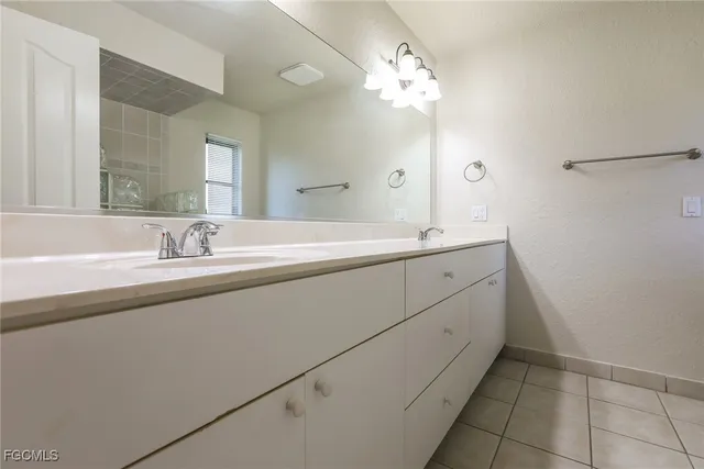 a spacious bathroom with a double vanity sink mirror and