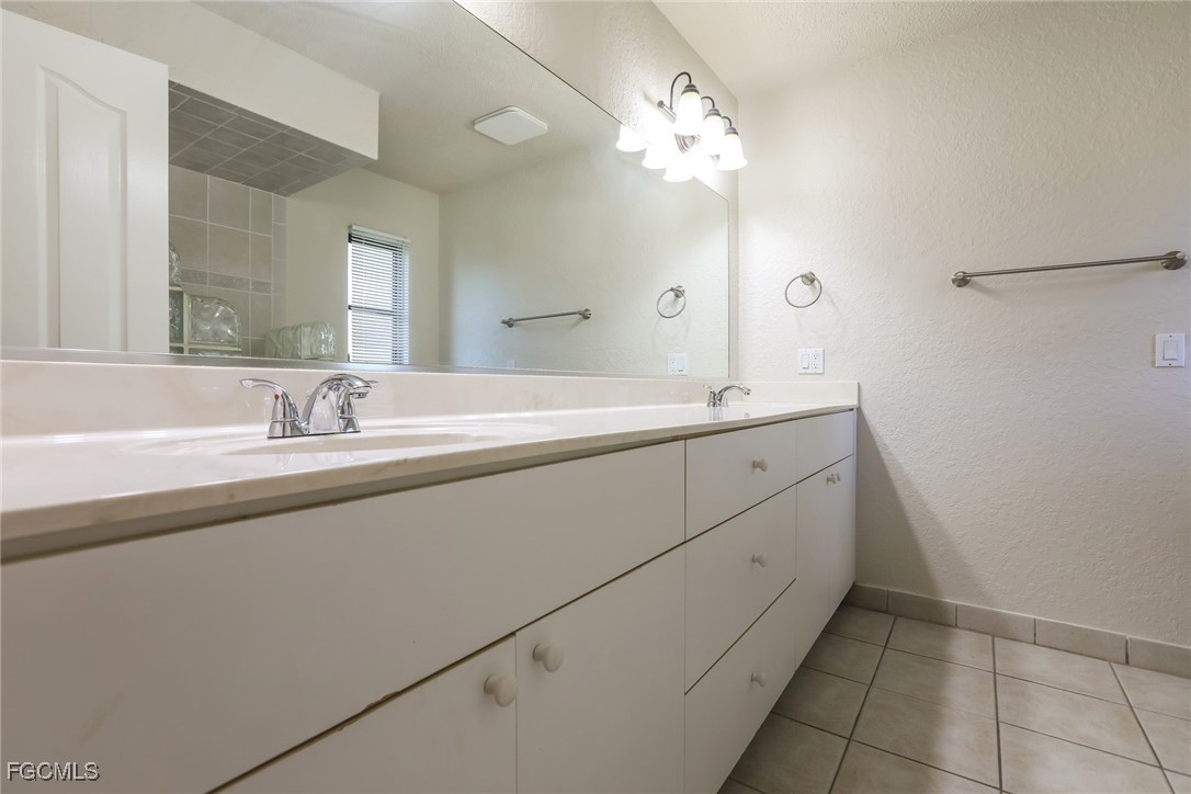 4024 Gingold Street Port Charlotte, FL 33948 - Photo 10 of 16 a spacious bathroom with a double vanity sink mirror and