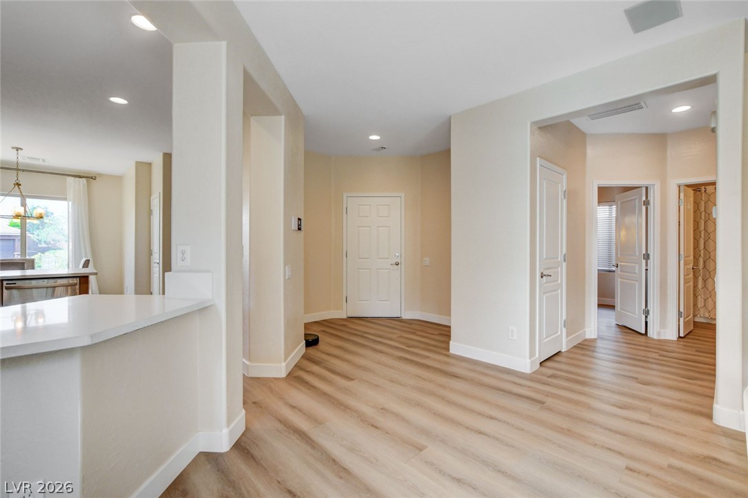 2649 Rue Marquette Avenue Henderson, NV 89044 - Photo 9 of 55 A spacious foyer offers a warm welcome, leading into an open-concept living area with durable wood flooring.