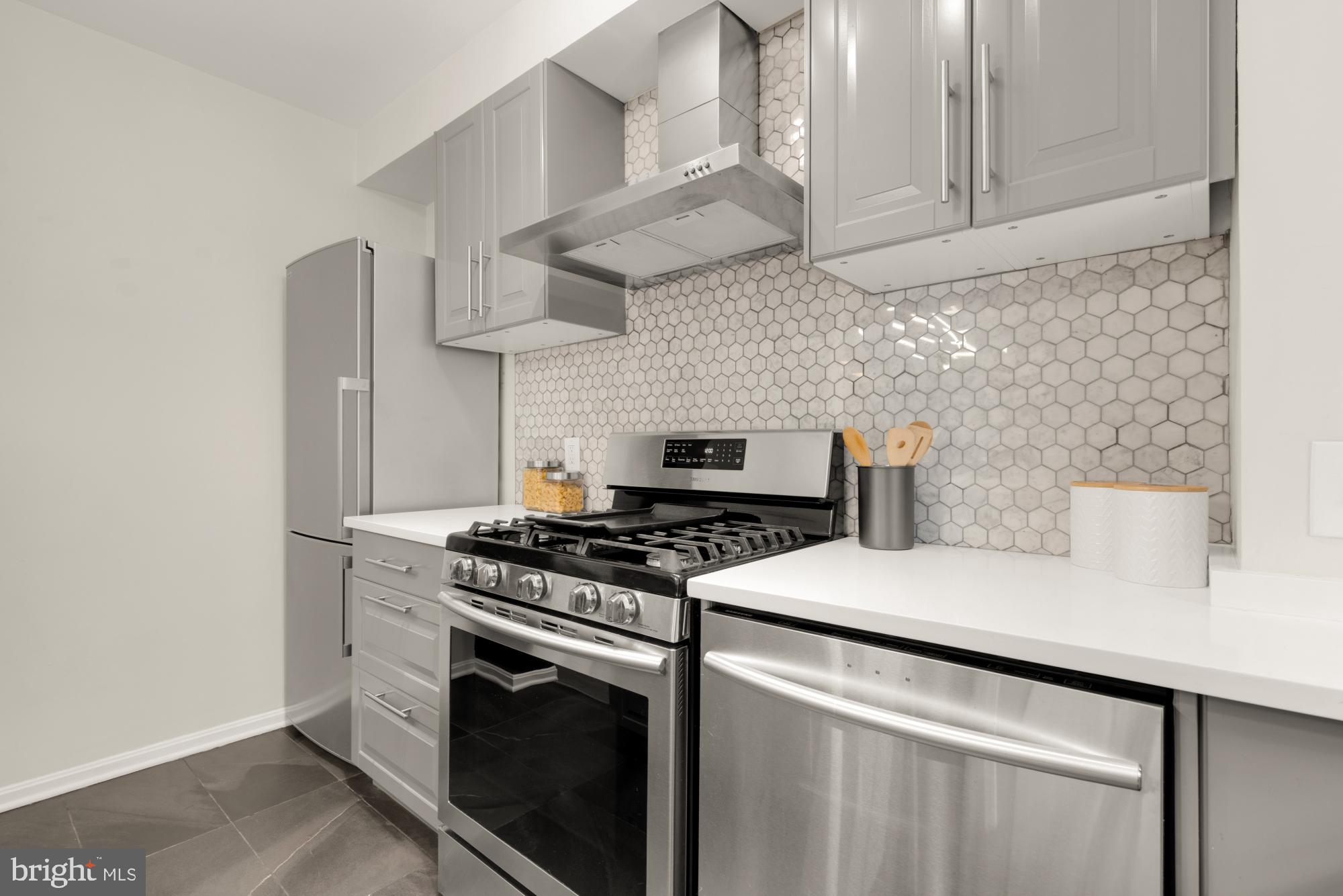 2801 Adams Mill Road Northwest, Unit 210 Washington, DC 20009 - Photo 11 of 32 a white stove top oven sitting inside of a kitchen