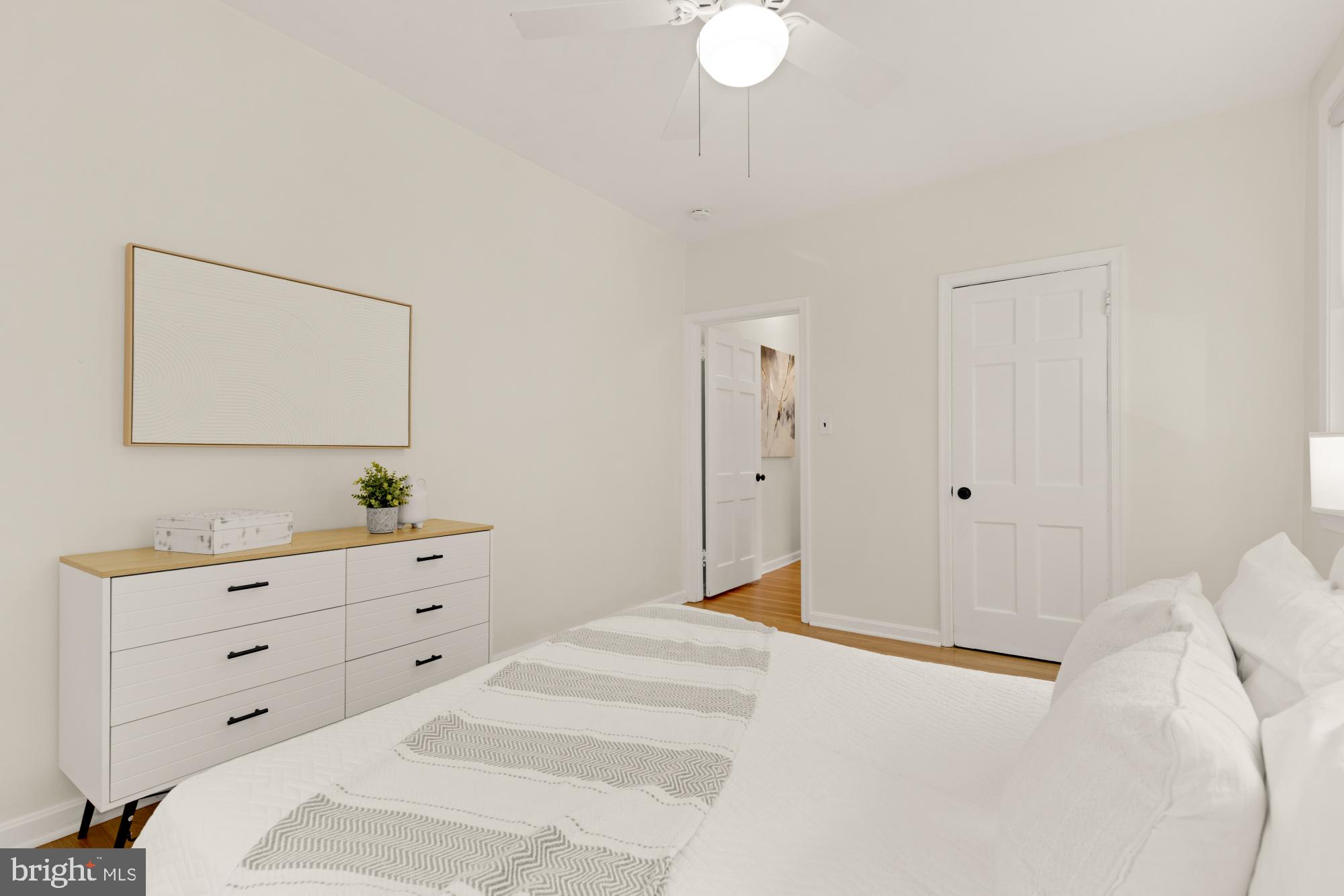 2801 Adams Mill Road Northwest, Unit 210 Washington, DC 20009 - Photo 15 of 32 a bedroom with a bed and a dresser