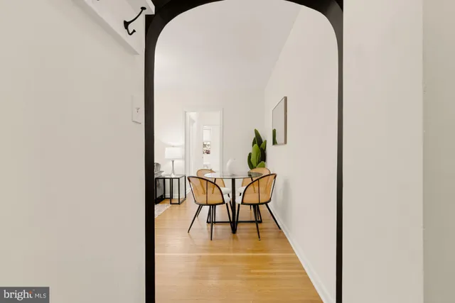 a living room with dining table and a kitchen view