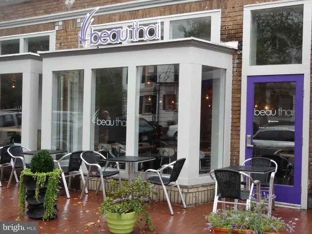 a front view of a building with outdoor seating