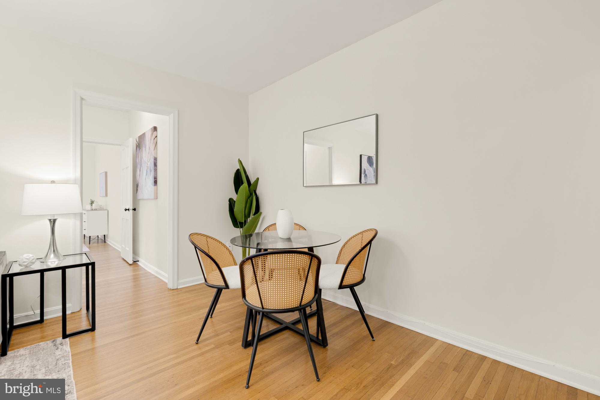 2801 Adams Mill Road Northwest, Unit 210 Washington, DC 20009 - Photo 8 of 32 a view of a dining room with furniture and wooden floor