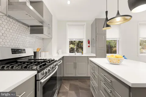 a kitchen with a sink stove and window