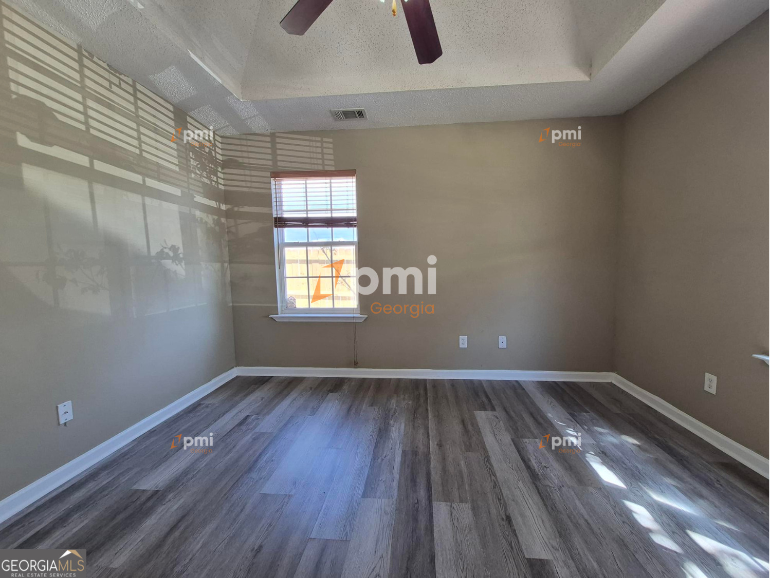342 Orchard Way Warner Robins, GA 31088 - Photo 11 of 15 a view of an empty room with wooden floor and a window
