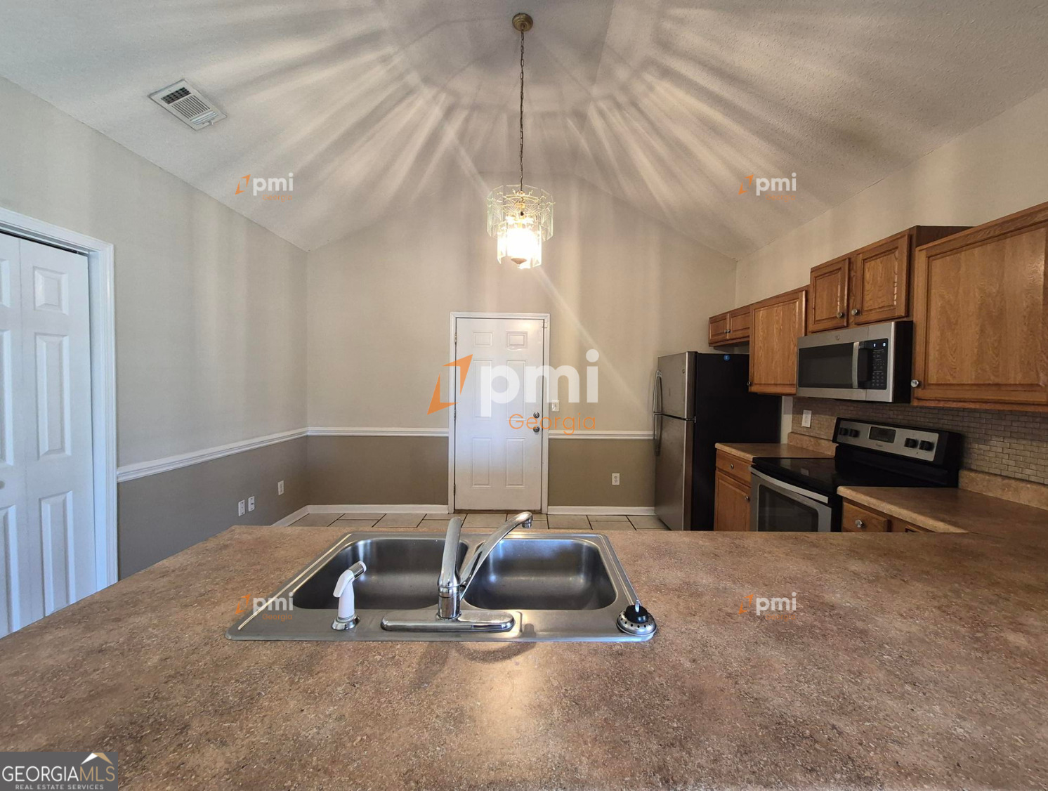 342 Orchard Way Warner Robins, GA 31088 - Photo 3 of 15 a room with furniture a flat screen tv and kitchen view