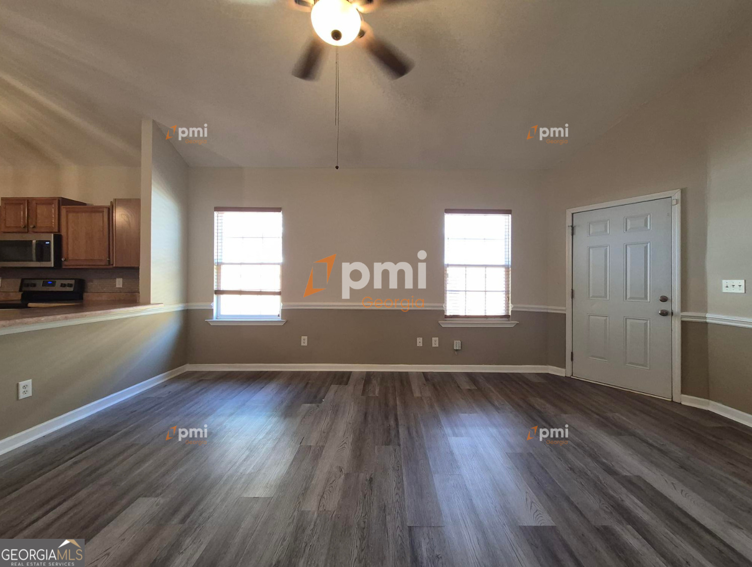 342 Orchard Way Warner Robins, GA 31088 - Photo 4 of 15 an empty room with wooden floor and windows