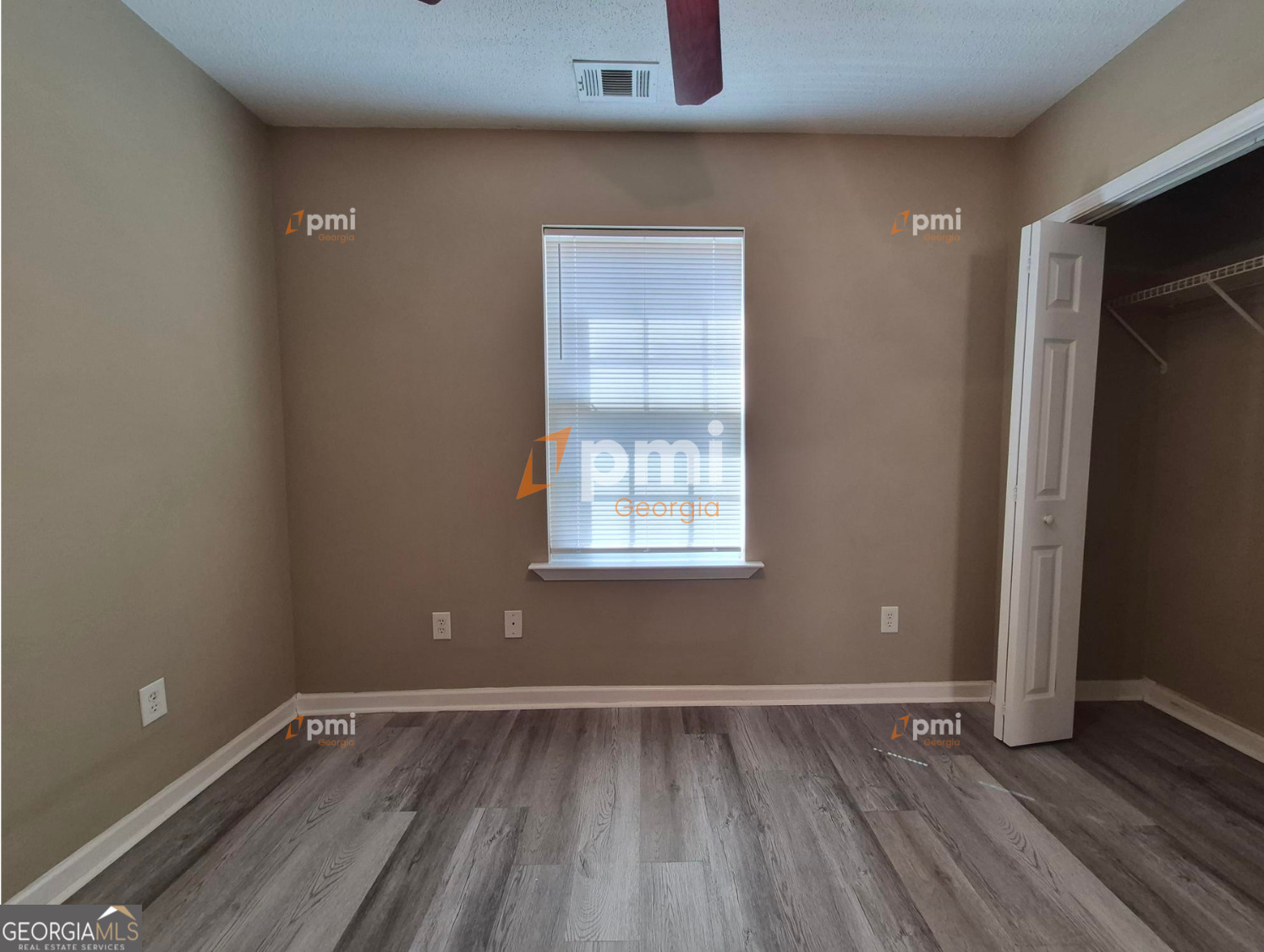 342 Orchard Way Warner Robins, GA 31088 - Photo 7 of 15 a view of an empty room with wooden floor and a window