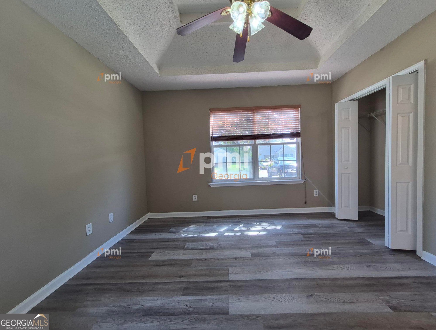 342 Orchard Way Warner Robins, GA 31088 - Photo 8 of 15 a view of an empty room with a window and wooden floor