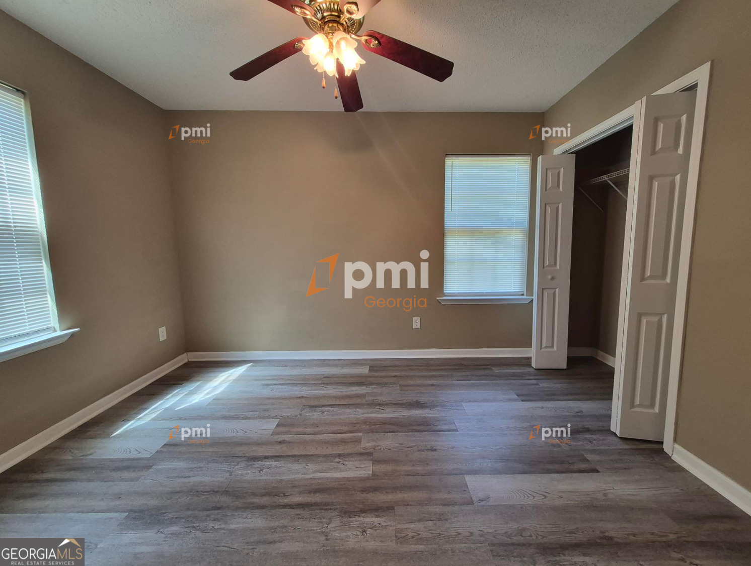 342 Orchard Way Warner Robins, GA 31088 - Photo 10 of 15 an empty room with wooden floor and windows