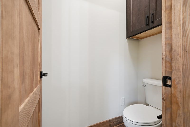 216 Old Orchard Road Ellijay, GA 30536 - Photo 6 of 59 a white toilet sitting next to a shower curtain