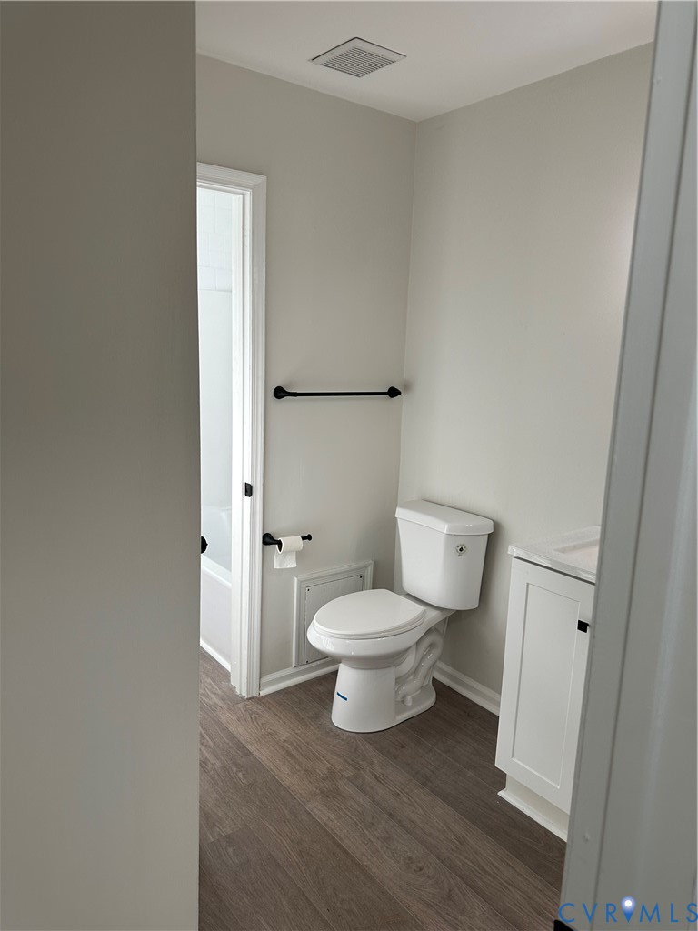9015 Covewood Road Glen Allen, VA 23060 - Photo 15 of 30 a white toilet sitting next to a bathroom sink and vanity