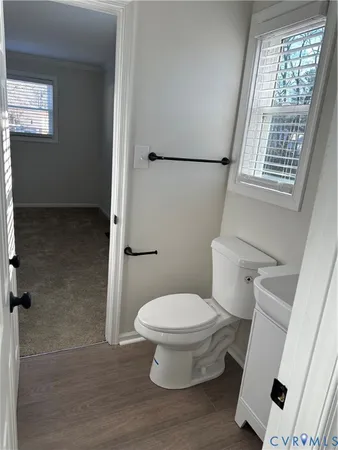 a white toilet sitting next to a window