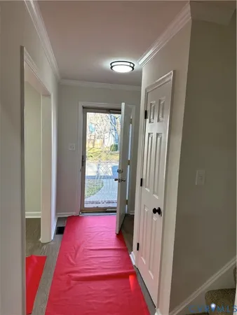 a hallway with two windows and a rug