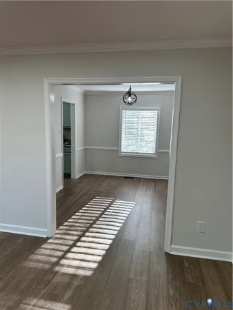 a view of wooden floor and windows in a room