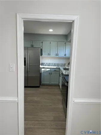 a kitchen with stainless steel appliances granite countertop a refrigerator and a sink