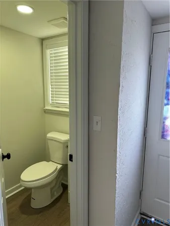 a white toilet sitting next to a bathroom sink