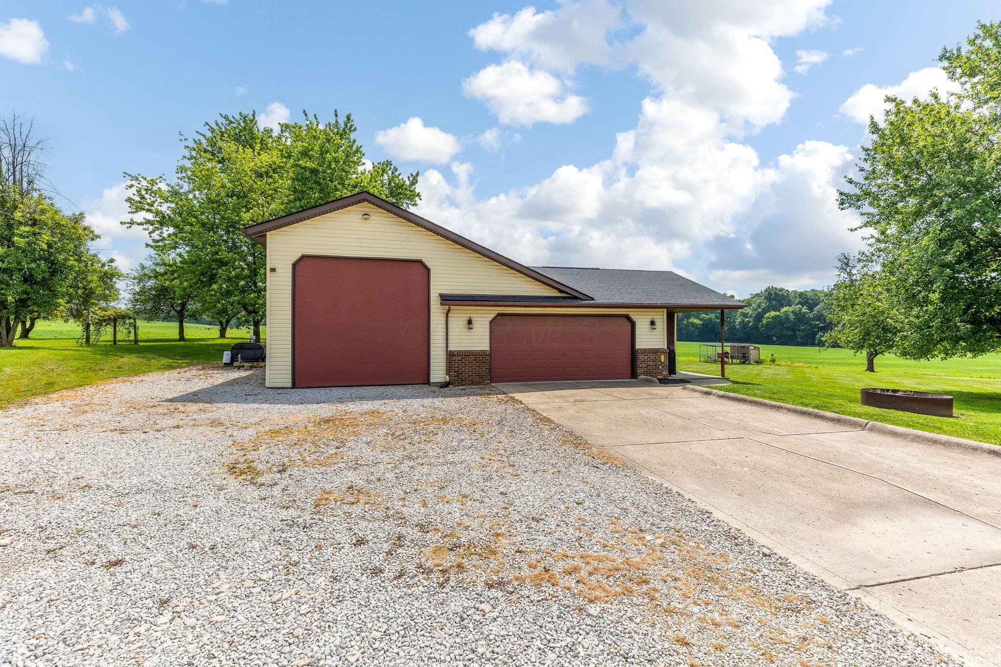 6651 Lancaster Road Hebron, OH 43025 - Photo 71 of 88 **Whether you’re dreaming of a small farm, need space for automotive work, or have an RV—**this 24' x 24' barn-style garage with 14-foot ceilings is a must-have. Versatile, spacious, and ready to suit your needs.