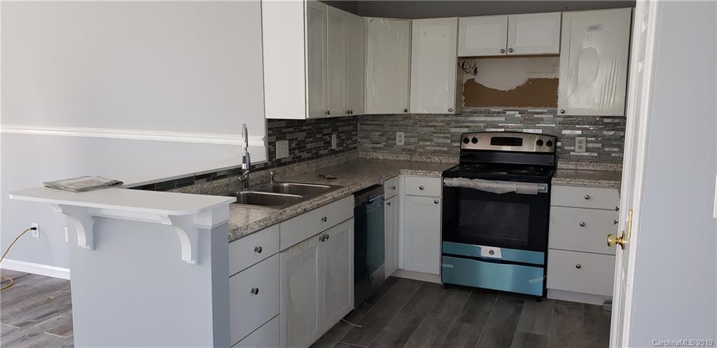 9610 Rau Court Charlotte, NC 28215 - Photo 4 of 10 a kitchen with a stove and a refrigerator