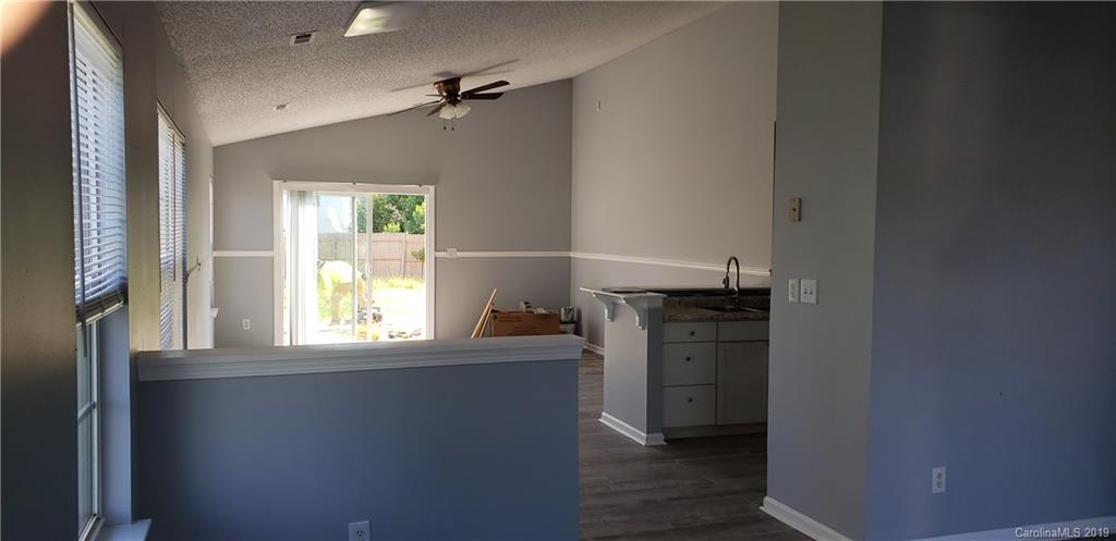 9610 Rau Court Charlotte, NC 28215 - Photo 6 of 10 a kitchen with a refrigerator and window