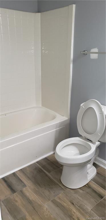 9610 Rau Court Charlotte, NC 28215 - Photo 7 of 10 a white toilet sitting next to a bath tub